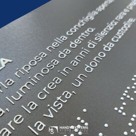targa braille con testo in nero a rilievo_